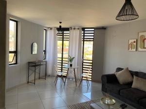 a living room with a couch and a table at Windhoek perfect stay in Windhoek