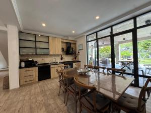 a kitchen and dining room with a table and chairs at RestCoast Villa in Shekhvetili