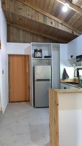 a kitchen with a stainless steel refrigerator and a counter at Almonte House in Puerto Plata +9 photos