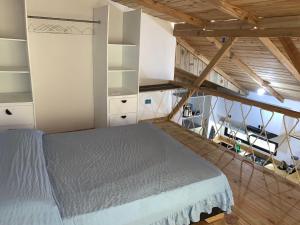 a bedroom with a large bed in a attic at Almonte House in Puerto Plata