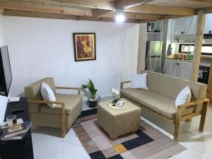 a living room with two chairs and a couch at Almonte House in Puerto Plata