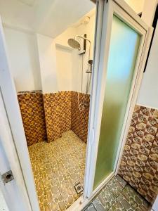 a shower with a glass door in a bathroom at Three bedroom apartment in Suva