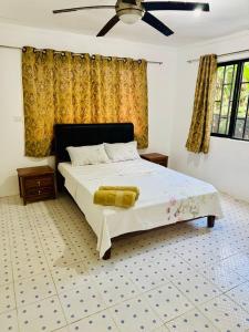 a bedroom with a bed and a ceiling fan at Three bedroom apartment in Suva