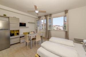 a room with a kitchen and a dining room with a table at Baldo View Studio in Toscolano Maderno