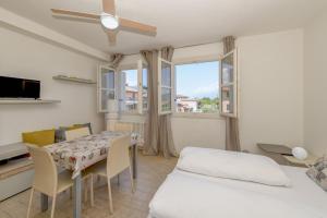a bedroom with a table and a bed and a window at Baldo View Studio in Toscolano Maderno