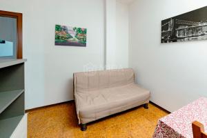 a chair in a room with two pictures on the wall at Arabic Sea Apartments in Porto Cesareo