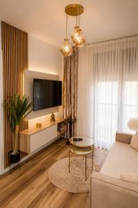 a living room with a couch and a table at VIP Apartman Friendly Home in Tuzla