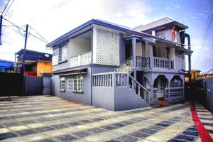 a house with a driveway in front of it at Nic's Inn in Freetown