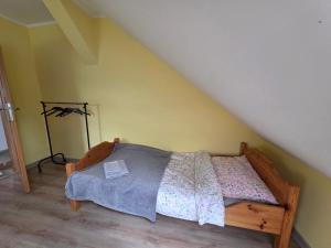 a bedroom with a bed with a book on it at Siedlisko Drwęck in Drwęck