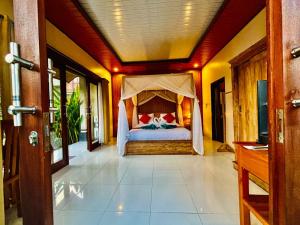 a bedroom with a bed with a canopy at pondok ubud nia cahya in Tegalalang +27 photos