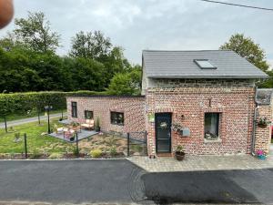 a brick house with a patio and a yard at Le gîte des Romains in Anor +19 photos