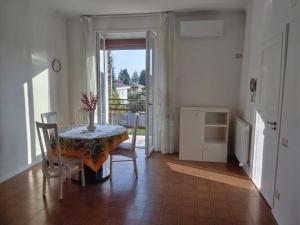 a dining room with a table and chairs and a window at Scer GEA in Cerro Maggiore +13 photos