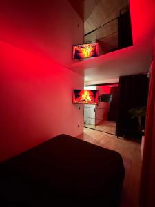 a living room with red lights on the wall at Appartement jacuzzi d'exception - proche Paris in Drancy