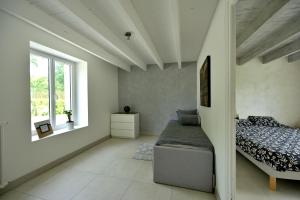 a bedroom with a bed and a window at Le Nid de Mazerolles in Sucé