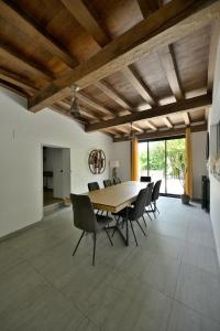 a dining room with a wooden table and chairs at Le Nid de Mazerolles in Sucé
