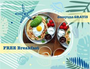 a plate of breakfast food with an egg and fruit at DUKASI ESCAPE playa LOS CORALES in Punta Cana