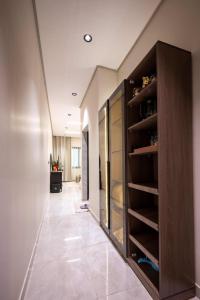 a hallway with a large wooden pantry with glass doors at استديو خاص in Al Khobar