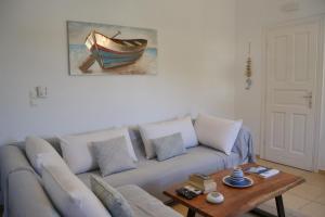 a living room with a couch and a table at Villa Giulia, Seaview Villa near Chora in Ios Chora