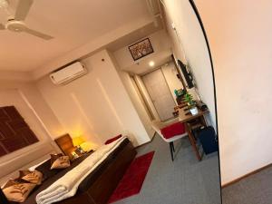 a mirror in a room with a bed and a desk at Midnight Atelier in Greater Noida