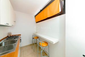a kitchen with a sink and a stove at Arabic Sea Apartments in Porto Cesareo +50 photos