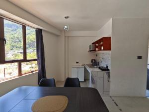 a kitchen with a table and chairs in a room at Casa Hormiga in Panajachel