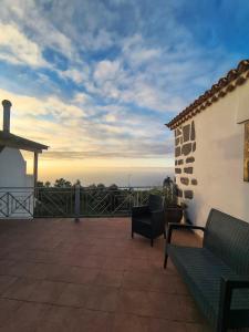 a patio with two benches on a roof at Hotel Rural Casablanca in Los Realejos