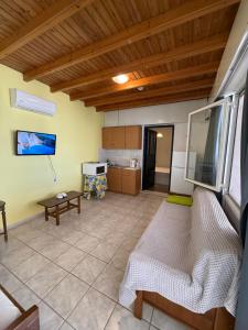 a living room with a couch and a table at Yellow Beach House in Logaras