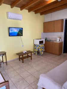 a kitchen with a counter and a table in a room at Yellow Beach House in Logaras +11 photos