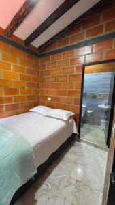 a bedroom with a bed and a glass window at chalet Relajante, En San Rafael in San Rafael