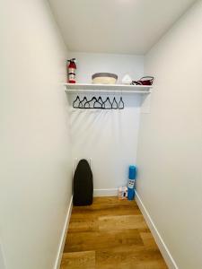 a hallway with white walls and a white shelf at Your Cozy NL Haven in St. John's +13 photos