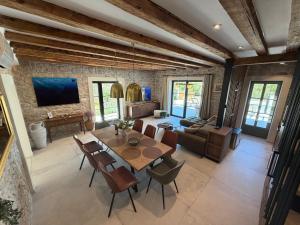 a living room with a wooden table and chairs at Heritage Villa Francheza-Elegant Stone villa near the Beach, Pašman Island , Ugrinić in Ugrinići
