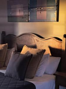 a bedroom with a bed with pillows on it at Hotel Rural Casablanca in Los Realejos