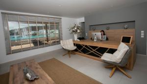 a woman sitting at a desk with a laptop at Thalassa boutique hotel-Adults only in Platis Gialos