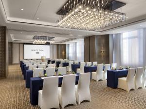 a conference room with blue tables and white chairs at Sofitel Xiong An in Baoding +60 photos