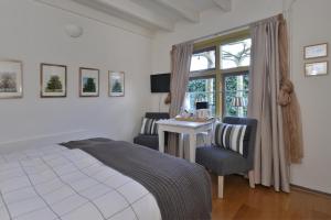 um quarto com uma cama, uma secretária e uma janela em Herberg De Ring em Dreischor