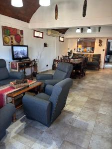 a living room with couches and a dining room at Cabañas Las Lomas in Juana Koslay 