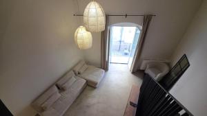a living room with two white couches and a window at La Pietra - Bari Vecchia, Vista Mare in Bari +43 photos