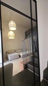 a living room with a mirror and a couch at La Pietra - Bari Vecchia, Vista Mare in Bari