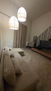 a living room with a couch and two lights at La Pietra - Bari Vecchia, Vista Mare in Bari