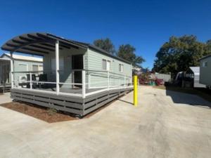 a mobile home with awning in a parking lot at Longreach Starlight Cabins - Boutique Outback Accommodation in Longreach