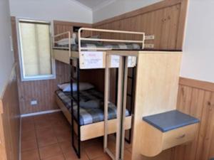a couple of bunk beds in a room at Longreach Starlight Cabins - Boutique Outback Accommodation in Longreach