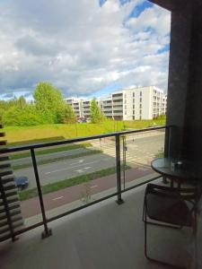 a balcony with a view of a road and buildings at Labaresto Plaza jums in Vilnius