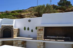 an outdoor pizza oven on the roof of a house at Villa Giulia, Seaview Villa near Chora in Ios Chora