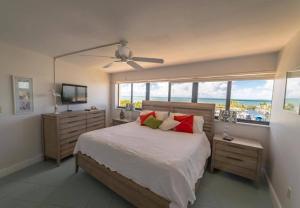 a bedroom with a bed with a view of the ocean at Oceanfront 5th Floor Penthouse in Key Largo +37 photos