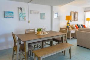 a dining room table and chairs in a living room at Oceanfront 5th Floor Penthouse in Key Largo