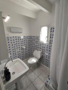 a bathroom with a white toilet and a sink at la crique in Sisco