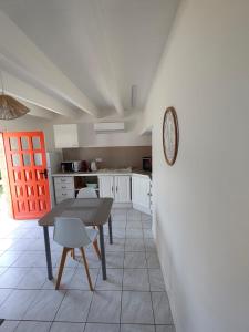 a kitchen with a table and chairs in a room at la crique in Sisco +5 photos