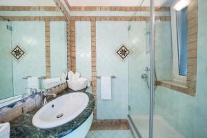 a bathroom with a sink and a shower at Villa Preziosa - Panoramic Sea View in Capri +56 photos