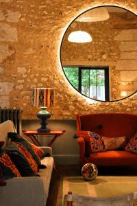a living room with two couches and a mirror at La Dime de Giverny - Chambres d'hôtes-Spa-Restaurant in Giverny