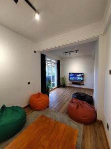 a living room with two bean bags and a television at Bunk 7 in Kandy